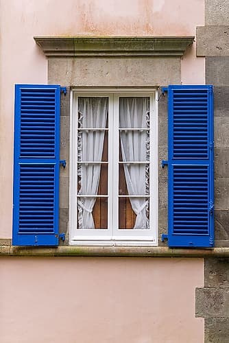 Furnas, Sao Miguel, Azores, Portugal. Blue shuttered window on a pink stucco building. Art Print